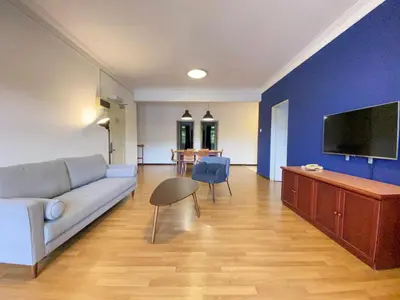 a living room with a couch and a flat screen tv at Parkland Suites in Brinchang