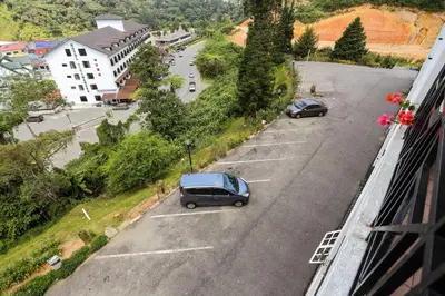 a car parked in a parking lot on a street at Parkland Suites in Brinchang