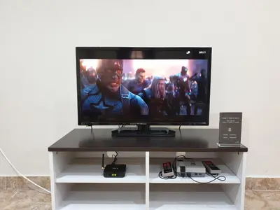 a flat screen tv sitting on top of a table at Taiping Cuti Homstay \u592a\u5e73\u7af9\u7b1b\u6c11\u5bbf 5mins to Kuala Sepetang in Taiping