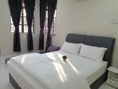 a bedroom with a white bed with a plant on it at Taiping Cuti Homstay \u592a\u5e73\u7af9\u7b1b\u6c11\u5bbf 5mins to Kuala Sepetang in Taiping