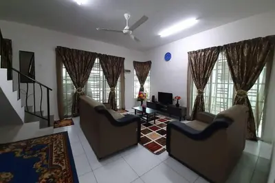 a living room with two couches and a television at HM Homestay Lahat, Station 18, Ipoh 'مسلم' in Lahat