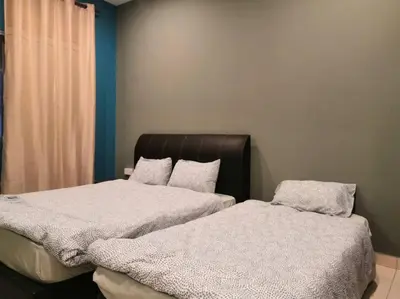 two beds sitting next to each other in a room at Green Hill Resort Tanah Rata 3R2B WiFi in Tanah Rata