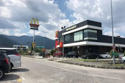 a mcdonalds restaurant with cars parked in a parking lot at Ipoh Meru Modern Cozy Home NAZ IPOH HOMESTAY in Ipoh