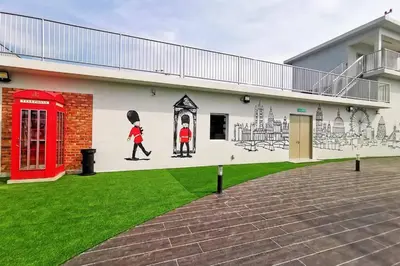 a mural on the side of a building with a red phone booth at The Venus Sitiawan Spacious High Floor Homestay 6 to 10 Pax in Kampong Lumut Kiri