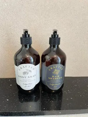two bottles ofappy syrup sitting on a shelf at ❈ Tropicana 218 by ALV Suites ❈ in George Town