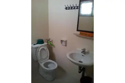 a bathroom with a toilet and a sink at Madani Muslim Hotel Cameron Highland in Cameron Highlands