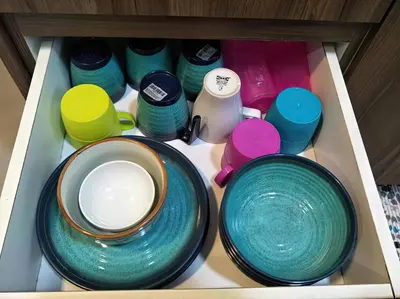 a drawer filled with bowls and other dishes at MiahPuteh Cozy Homestay Cameron Highlands Pasar Malam in Brinchang