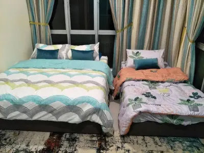 two beds sitting next to each other in a room at MiahPuteh Cozy Homestay Cameron Highlands Pasar Malam in Brinchang