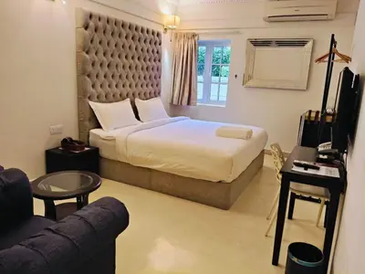a hotel room with a bed and a couch at Seriental Hotel I check in 3pm-11pm only in Tanjong Tokong