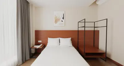 a bedroom with a bed with a wooden head board at VISTA HOTEL in Kampar