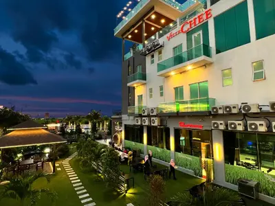 a view of the front of a hotel at night at Villa Chee in Sekincan