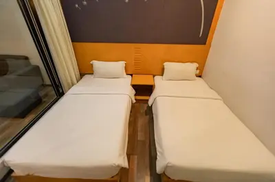 a pair of beds in a small room at Hills Aranda Nova Hotel in Cameron Highlands
