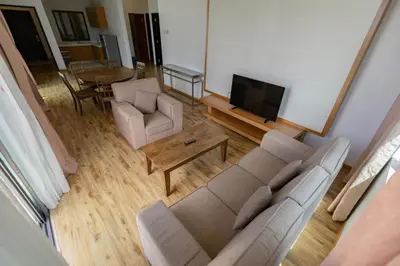 a living room with a couch and a tv at Hills Aranda Nova Hotel in Cameron Highlands