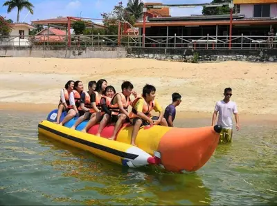 a group of people sitting on a raft in the water at Teluk Batik 17ParadiseHome Private Pool Karaoke Snooker BBQ 15pax in Lumut