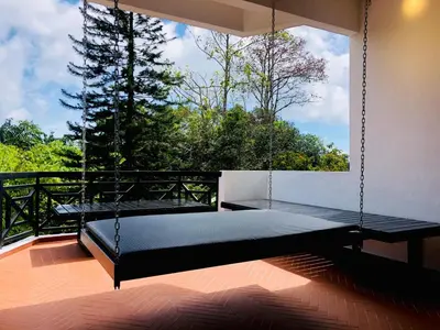 a swing bed in a room with a window at 80 Colonie Fraser's Hill 8pax in Bukit Fraser