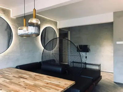 a living room with a black couch and a wooden table at 80 Colonie Fraser's Hill 8pax in Bukit Fraser