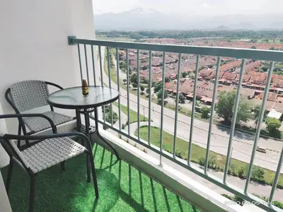 a balcony with a table and chairs and a view at HOMESTAY NazIPOH Meru in Ipoh