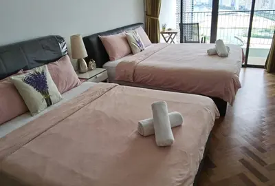 two beds in a room with two white towels on them at Landmark Lovely Coast View King Suite#500mbpsWifi#Netflix in Tanjong Tokong
