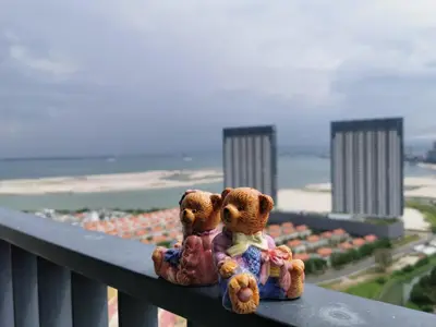 two teddy bears sitting on top of a balcony at Landmark Lovely Coast View King Suite#500mbpsWifi#Netflix in Tanjong Tokong