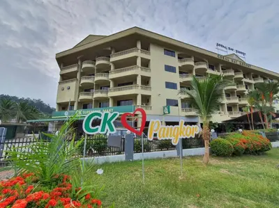 a hotel with a sign in front of a building at Pangkor Coral Bay Resort(2 bedrooms) in Pangkor