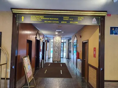 a hallway in a building with a sign over the door at Pangkor Coral Bay Resort(2 bedrooms) in Pangkor