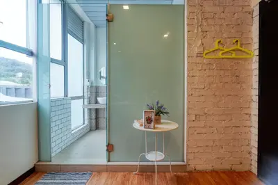a glass door in a room with a table at Snooze TOO in Brinchang