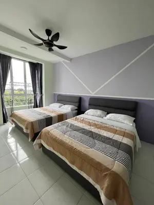 a bedroom with two beds and a ceiling fan at Cameron Emerald Avenue @ Brinchang in Cameron Highlands