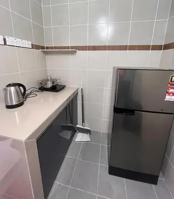 a small kitchen with a counter and a refrigerator at Cameron Emerald Avenue @ Brinchang in Cameron Highlands