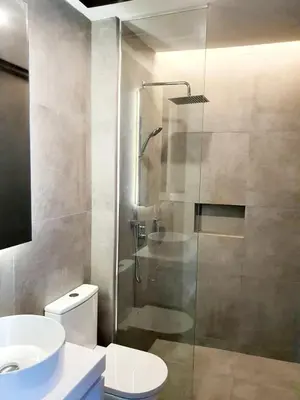 a bathroom with a shower and a toilet and a sink at Luxurious 7 BR Heritage House in UNESCO Historic Geogetown in George Town