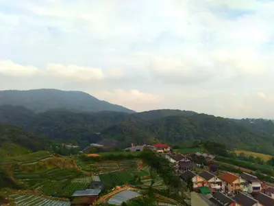 a view of a village with mountains in the background at Crown Imperial Court Apt at Brinchang Centre in Brinchang