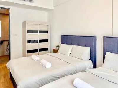 a bedroom with two beds with towels on them at Georgetown Tropicana 218 Apartment in George Town