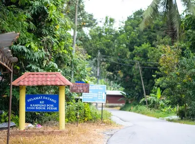 a sign on the side of a road at Cinta Abadi Resort in Bidur