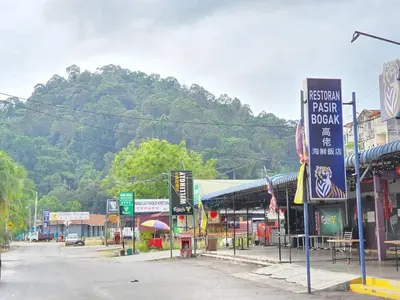 an empty street in a town with a mountain in the background at Pangkor Coral Bay Resort(3 bedrooms) \u4f11\u606f\u5c0f\u7ad9 in Pangkor