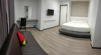 a hotel room with a bed and a couch at Hotel Lam Seng in Pantai Remis