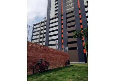 a brick wall with bikes parked next to a tall building at \u805a\u4e50\u5c4b\u6c11\u5bbfJyuraku homestay The venus sitiawan in Sitiawan