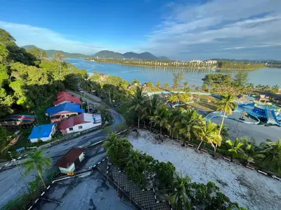 an aerial view of a town next to a river at EagleNest at Marina Cove Resort in Lumut