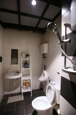 a bathroom with a toilet and a sink at Private Getaway (Private Cinema, Swing & more!) at CEO Penang in Bayan Lepas