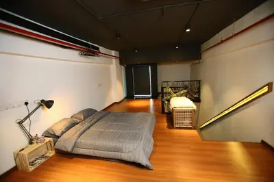 a bedroom with a bed in the middle of a room at Private Getaway (Private Cinema, Swing & more!) at CEO Penang in Bayan Lepas