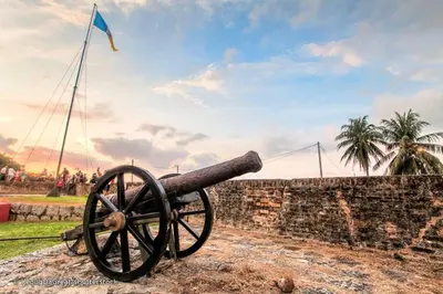 a cannon sitting on top of a stone wall at EEs Whale House - Homestay 3 min walk to beach in Batu Ferringhi