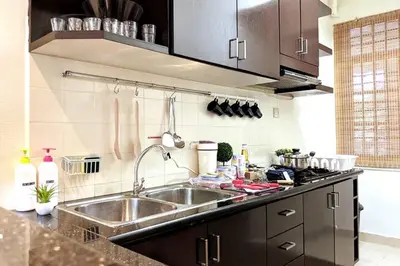 a kitchen with a sink and a counter top at EEs Whale House - Homestay 3 min walk to beach in Batu Ferringhi