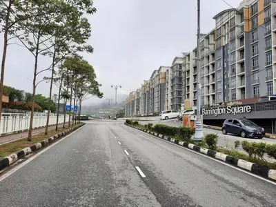 an empty street in a city with buildings at Lily Homestay Barrington Square Cameron Highlands. in Brinchang