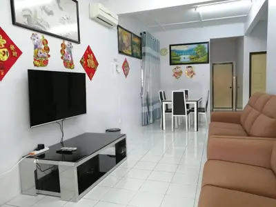 a living room with a flat screen tv on a wall at YITOM Homestay\u6613\u901a\u6c11\u5bbf in Sungai Besar