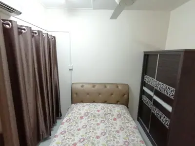 a bedroom with a bed and a dresser at YITOM Homestay\u6613\u901a\u6c11\u5bbf in Sungai Besar