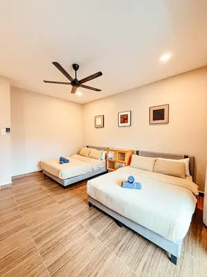 a room with two beds and a ceiling fan at Golden Sweet Home @ Golden Hills (Night Market, \u591c\u5e02) in Tanah Rata