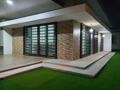 a living room with a brick wall and green carpet at Homestay D'Bertam, Kepala Batas, Penang, Muslim Saja in Kepala Batas