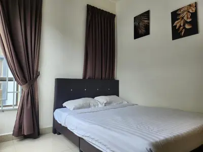 a bedroom with a bed and a window with curtains at Relax Bear Homestay in Tanah Rata