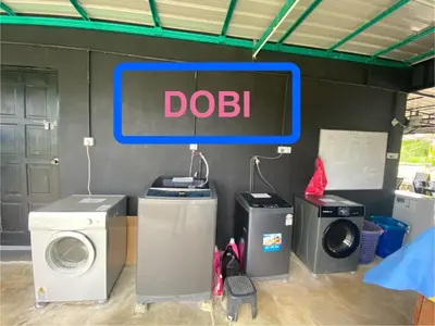 a doil sign on a wall next to washing machines at Sacha Homestay in Baling