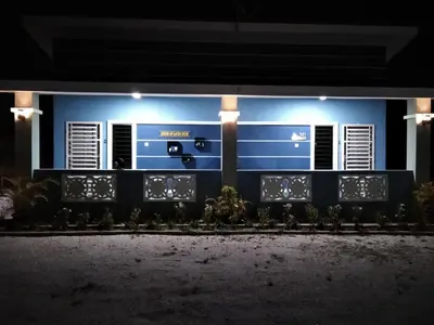 a blue house with lights on it at night at Sacha Homestay in Baling