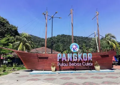 a large wooden boat in front of a sign at WORLD KIDS FANTASY in Lumut