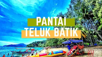 a group of people on a beach with boats at WORLD KIDS FANTASY in Lumut